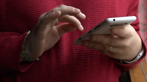 Closeup on woman's hands texting on a smartphone at home Stock Footage 60576368