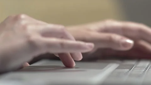 Closeup of woman's hands toucing the touch pad on a laptop in the office, bus Stock Footage 165373628