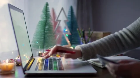 Closeup Of Woman's Hands, Uses A Notebook And Laptop To Christmas Shop Online Video stock 82335007