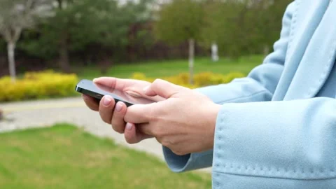 Closeup of woman's hands uses smartphone with green screen Stock Footage 286134521