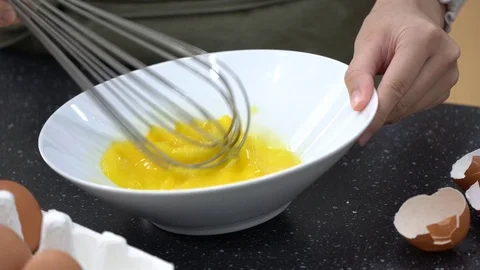 Closeup on woman's hands whisking eggs in bowl Stock Footage 95967812