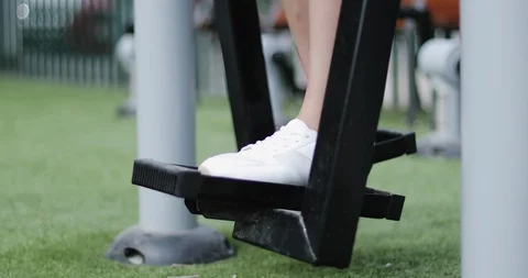 Closeup of a woman's legs on a simulator in park. Stock Footage 102738480