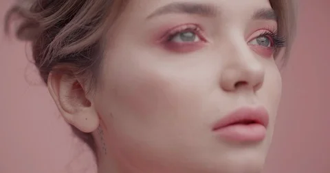 CloseUp of Woman’s strong Face in front of Camera, having creative Makeup and Stock Footage 124989455