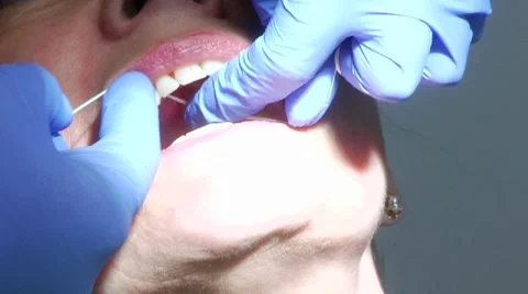 Closeup of woman's teeth being flossed at dentist Stock Footage 8653123