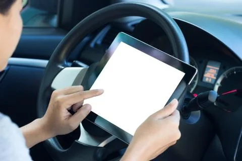 Closeup women using tablet inside car Stock Photos