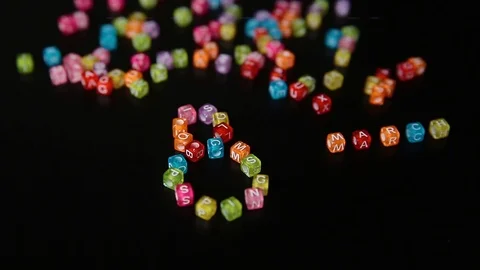 Closeup word "8 MARCH" collected from colorful cubes with letters on black table Stock Footage 100577275