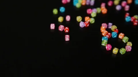 Closeup word "8 MARCH" collected from colorful cubes with letters on black table Stock Footage 100577284