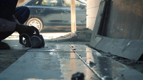 Closeup of worker cutting marble tile using electric cutter machine 스톡 동영상 319074210