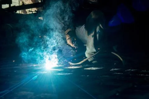 Closeup worker doing the welding in a workshop Stock Photos