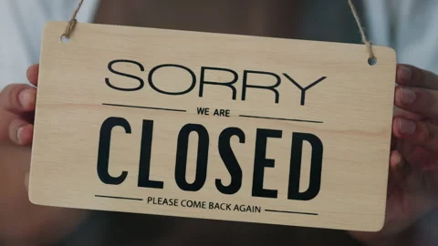 Closeup of worker hands turning sign Open to Sorry We are Closed on glass door Stock Footage 306416583