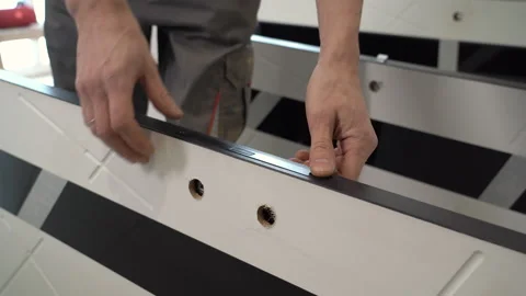 Closeup of worker inserting door mechanism into interior door Video stock 264034997