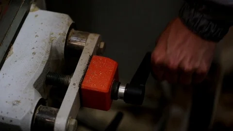Closeup of worker man adjusts carpentry mashine at furniture factory Stock Footage