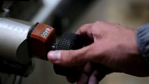 Closeup of worker man adjusts carpentry mashine at furniture factory Stock Footage 78022607