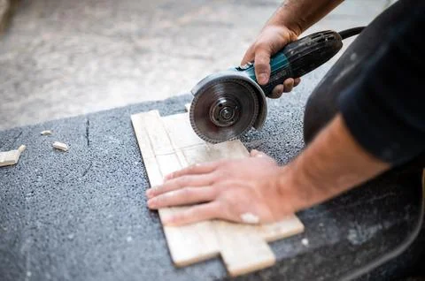 Closeup of a worker use cutting machine to cut a ceramic tile Stock Photos