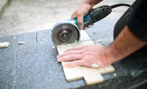 Closeup of a worker use cutting machine to cut a ceramic tile Stock Photos