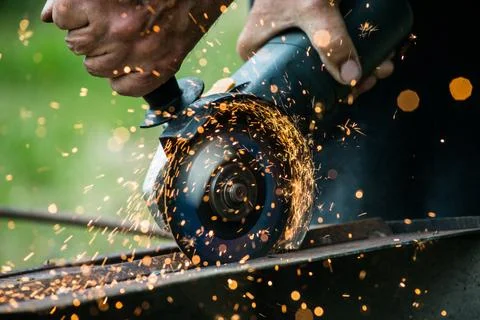 Closeup of worker using a grinder on a metal plate Stock Photos