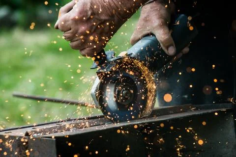 Closeup of worker using a grinder on a metal plate Stock Photos