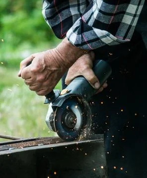 Closeup of worker using a grinder on a metal plate Stock Photos