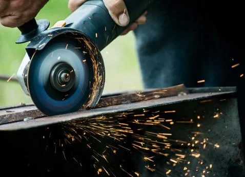 Closeup of worker using a grinder on a metal plate Stock Photos