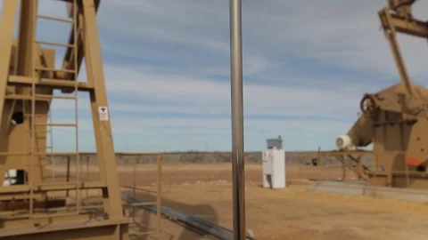 Closeup of working oil derrick pump in petroleum field D Stock Footage 125638786