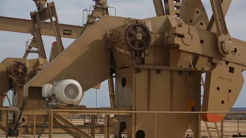 Closeup of working oil derrick pump in petroleum field C Stock Footage 125638827