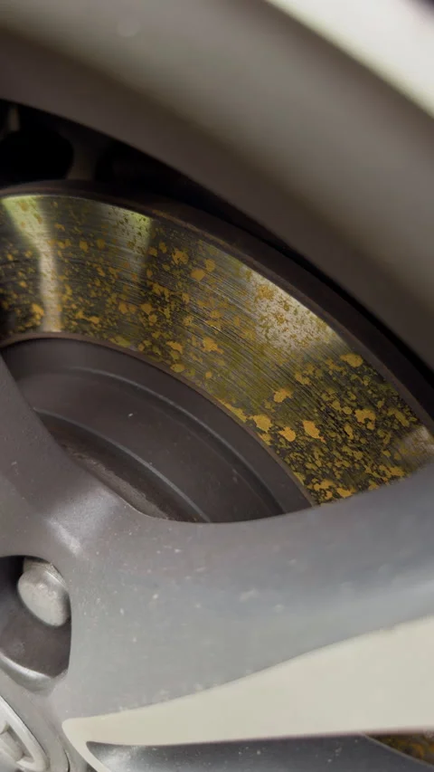 Closeup of worn brake disc inside car wheel with rust spots and metallic surface 스톡 동영상 346558188