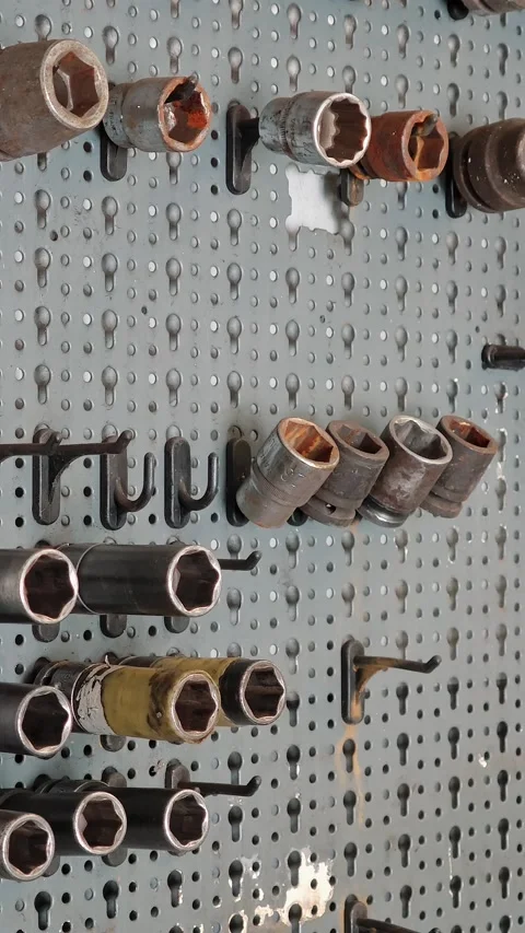Closeup of Worn Socket Wrenches and Tools on Pegboard at Tire Service Stock Footage 332828772