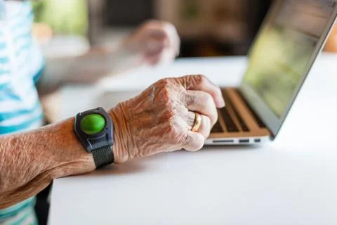 Closeup of wrinkled hand using a laptop Stock Photos