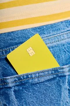 Closeup of a yellow debit card with a microchip sticking out of the back po.. Stock Photos