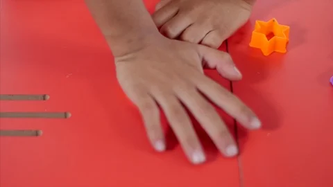 Closeup of a young boy hands playing with colorful clay / dough and making it... Stock Footage 114055279