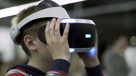 Closeup of Young boy with a small hands holding virtual reality glasses Stock Footage 84332158