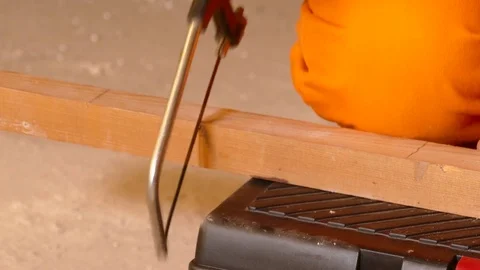 Closeup of young constructor sawing wood with saw Stock Footage 71941637