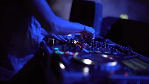 Closeup of young DJ turning knobs on DJ mixer console in a disco. 스톡 동영상 103632922