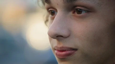 Closeup young face of cute boy outdoors Stock Footage 97409019