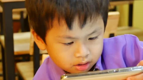 Closeup of young happy boy face looking at smartphone at night 스톡 동영상 66921086