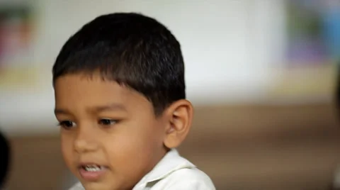 Closeup of young Indian boy playing games in preschool class in rural India Stock Footage 33834695