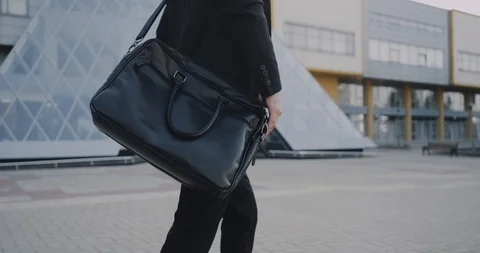 Closeup young man go to work with his briefcase. red epic. 4k Stock Footage 91068727