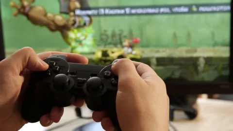 Closeup of young man hands playing video games on gaming console in front Stock Footage 129661163