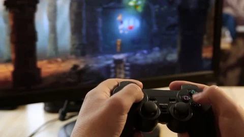 Closeup of young man hands playing video games on gaming console in front Stock Footage 129661326