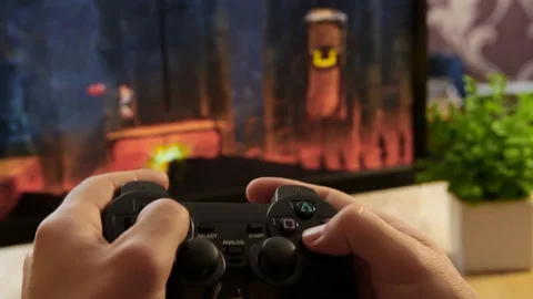 Closeup of young man hands playing video games on gaming console in front Stock Footage 129661496