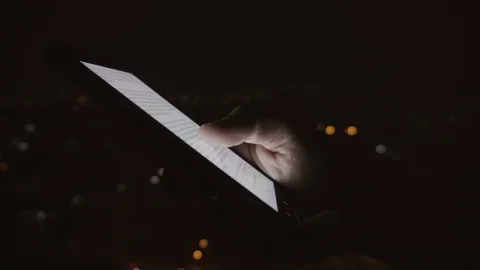 Closeup of young man hands scrolling pictures on phone screen Stock Footage 83575673