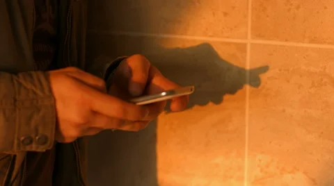 Closeup of young man hands typing sms scrolling pictures on phone Видео 50191780