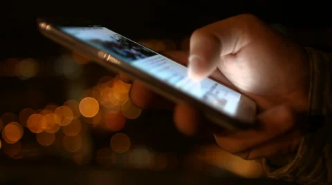 Closeup of young man hands typing sms scrolling pictures phone Video stock 50192621