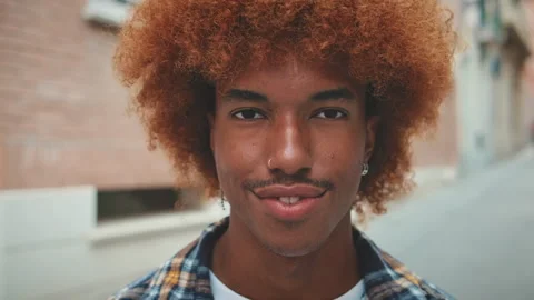 Closeup, young man raises his head, opens his eyes and smiles looking at the Stock Footage 250843647