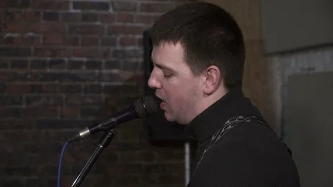 Closeup of a young man singing to the microphone Stock Footage 74207675