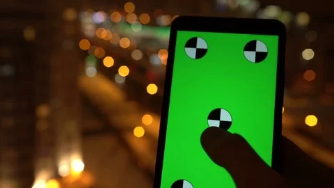 Closeup. Young man is using Smartphone with Green Screen at Evening Time in Stockbeeldmateriaal 71103367