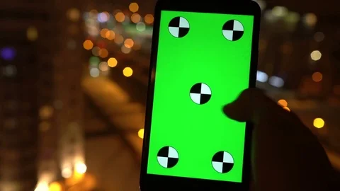 Closeup. Young man is using Smartphone with Green Screen at Evening Time in Video stock 71103935