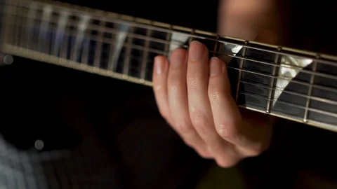 Closeup of young man's guy hands playing electric guitar, slow motion Video stock 118883794