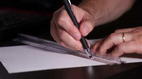 Closeup of young man's hands drawing at desk shot in real time Video stock 116625445