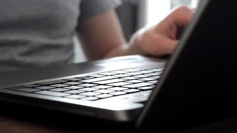 Closeup of young man's hands with a wedding ring typing on keyboard at home Stock Footage 84101880